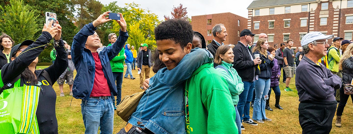 A student receives a hug during Fall Family Weekend